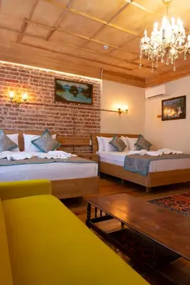 a bedroom with two beds and a brick wall at İstanbul Eagle's Nest Boutique Hotel in Istanbul