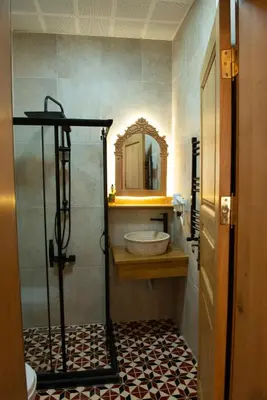 a bathroom with a shower with a sink and a mirror at İstanbul Eagle's Nest Boutique Hotel in Istanbul