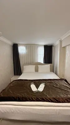 a large white bed with a bow tie on it at New Hotel Harbiye in Istanbul