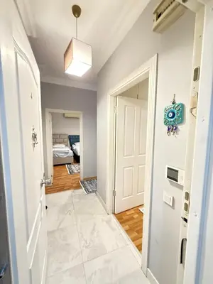 a hallway with a white door and a bedroom at New Hotel Harbiye in Istanbul