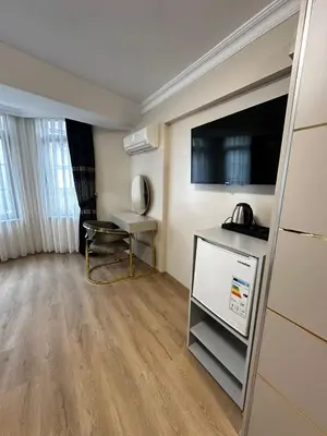a living room with a television and a table at New Hotel Harbiye Studio in Istanbul