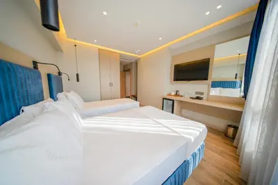 a hotel room with two beds and a television at The Palm Bosphorus Hotel in Istanbul