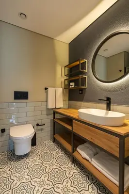 a bathroom with a sink and a toilet and a mirror at The Superior Living Kağıthane in Istanbul