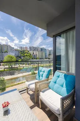 a balcony with wicker chairs and a view of a city at The Superior Living Kağıthane in Istanbul