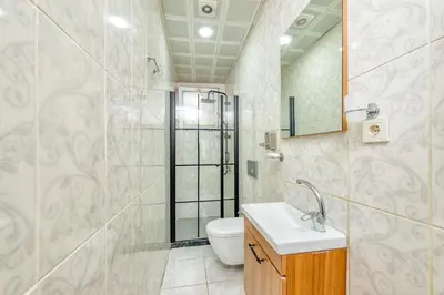 a bathroom with a toilet and a sink and a shower at Pio Apart Hotel in Istanbul