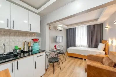 a kitchen and living room with a bed in a room at Pio Apart Hotel in Istanbul