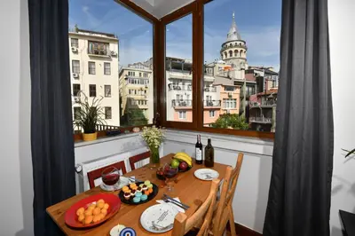 a dining room table with a view of a city at Taksim-Galata Tower Is Almost In Your Bedroom And In The Balconies Rooftop Terrace with Golden Horn View in Istanbul