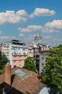 a view of a city with buildings and a tower at Taksim-Galata Tower Is Almost In Your Bedroom And In The Balconies Rooftop Terrace with Golden Horn View in Istanbul