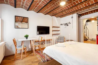a bedroom with a bed and a table and chairs at Armel Homes Beyoğlu in Istanbul