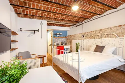 a bedroom with a white bed and a brick wall at Armel Homes Beyoğlu in Istanbul