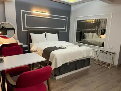 a bedroom with a bed and a table and chairs at Fabesco Suite in Istanbul