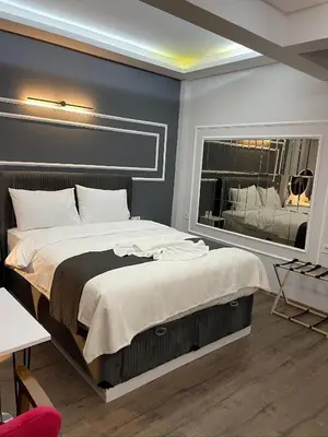 a bedroom with a large bed and a large window at Fabesco Suite in Istanbul