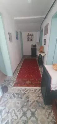 a room with a bed and a red carpet at Town center house in İznik