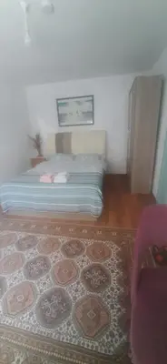 a bedroom with a bed and a rug in a room at Town center house in İznik