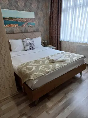 a bedroom with a large bed with white sheets at Nagehan Hotel Old City in Istanbul