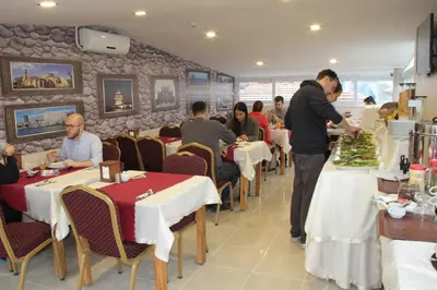 a group of people sitting at tables in a restaurant at Nagehan Hotel Old City in Istanbul