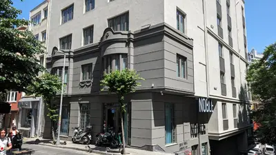 a building on the corner of a city street at Noble Pangaltı in Istanbul