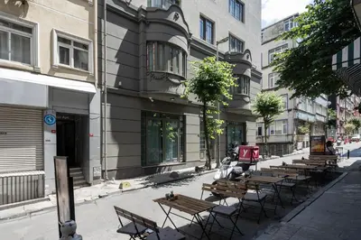 a row of wooden benches on a city street at Noble Pangaltı in Istanbul