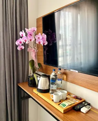 a table with a vase of flowers on a television at Vera Taksim Hotel in Istanbul