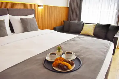 a hotel room with two beds with a tray of food at Vera Taksim Hotel in Istanbul