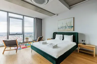 a bedroom with a large bed and large windows at Gorgeous 3BD2Bath Bright Airy Penthouse! #355 in Istanbul
