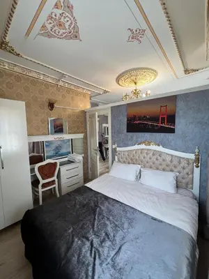 a bedroom with a large bed and a desk at Mihri Hatun Suite in Istanbul