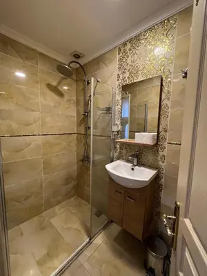 a bathroom with a sink and a shower at Mihri Hatun Suite in Istanbul