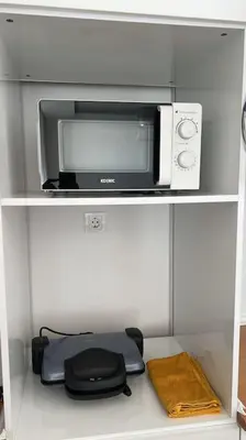 a microwave and a toaster oven on a shelf at Cozy Homes - 2 Rooms & 1 Living room Apartment in Esenyurt