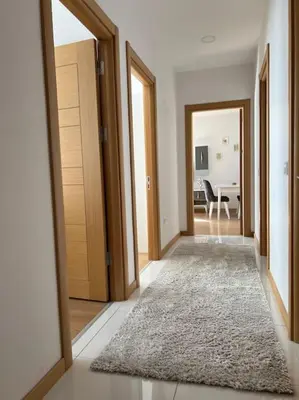 a hallway with doors and a rug in a room at Cozy Homes - 2 Rooms & 1 Living room Apartment in Esenyurt