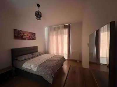 a bedroom with a bed and two windows at Cozy Homes - 2 Rooms & 1 Living room Apartment in Esenyurt