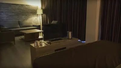 a living room with a couch and a flat screen tv at Sun Suites in Istanbul