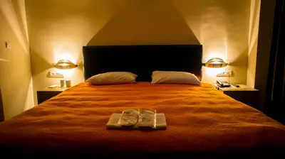 a bed with a pair of shoes sitting on it at Sun Suites in Istanbul