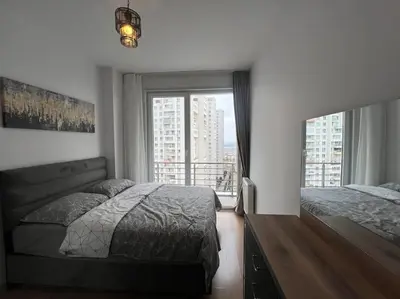 a bedroom with two beds and a large window at Cozy Homes 2 Room Apartment Well Designed in Esenyurt
