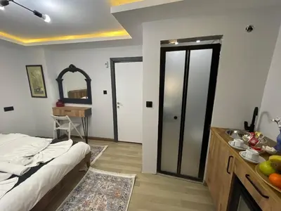 a bedroom with a bed and a sink and a mirror at Le Valeria Deluxe in Istanbul