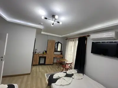 a bedroom with two beds and a flat screen tv at Le Valeria Deluxe in Istanbul