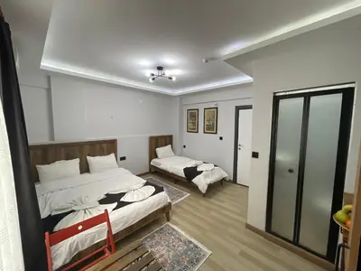 a bedroom with two beds and a mirror at Le Valeria Deluxe in Istanbul