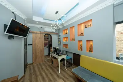 a living room with a yellow couch and a tv at Le Valeria Deluxe in Istanbul