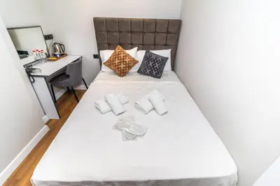a small bedroom with a bed with a desk at Wond House in Istanbul