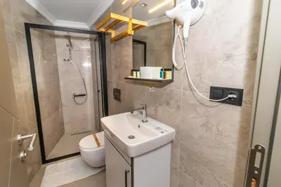 a bathroom with a sink and a shower and a toilet at Wond House in Istanbul