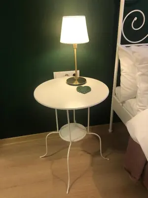 a table with a lamp on it next to a bed at Sapphire Suites Taksim in Istanbul