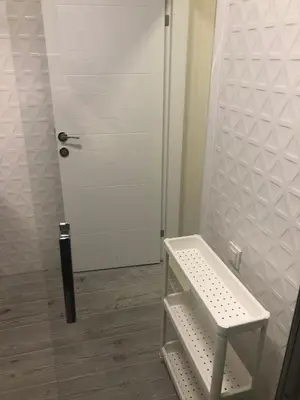 a bathroom with a white door and a shelf at Sapphire Suites Taksim in Istanbul