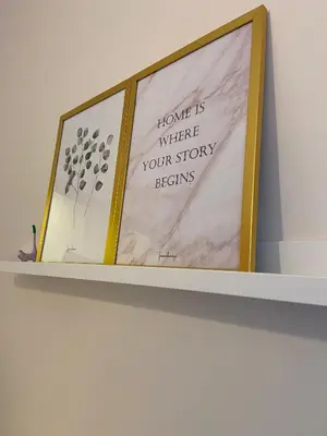 a shelf with three pictures on top of it at Sapphire Suites Taksim in Istanbul