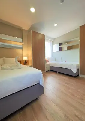 a large bedroom with two beds and wooden floors at Frezya Family Hotel in Istanbul