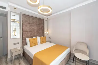 a hotel room with a bed and a chair at Massimo Hotel in Istanbul