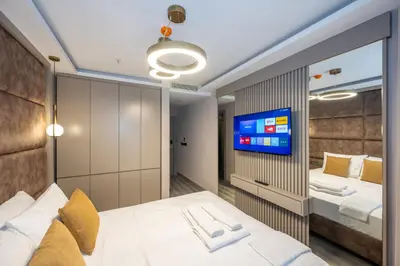 a bedroom with a bed and a tv on a wall at Massimo Hotel in Istanbul