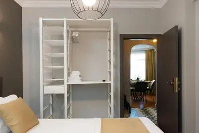 a bedroom with a bed and a white book shelf at The best of the Bosphorus & comfortable apartment in Istanbul