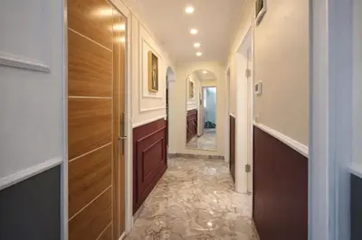 a hallway with wooden doors and a tile floor at Konak Grand Bella Sultanahmet in Istanbul