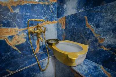 a bathroom with a yellow toilet in a blue wall at Konak Grand Bella Sultanahmet in Istanbul