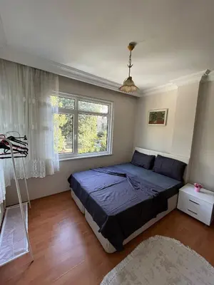 a bedroom with a bed and a window at Acıbadem Kadıköy Daire in Istanbul