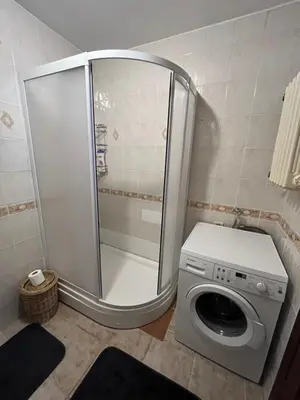 a bathroom with a washing machine and a shower at Acıbadem Kadıköy Daire in Istanbul